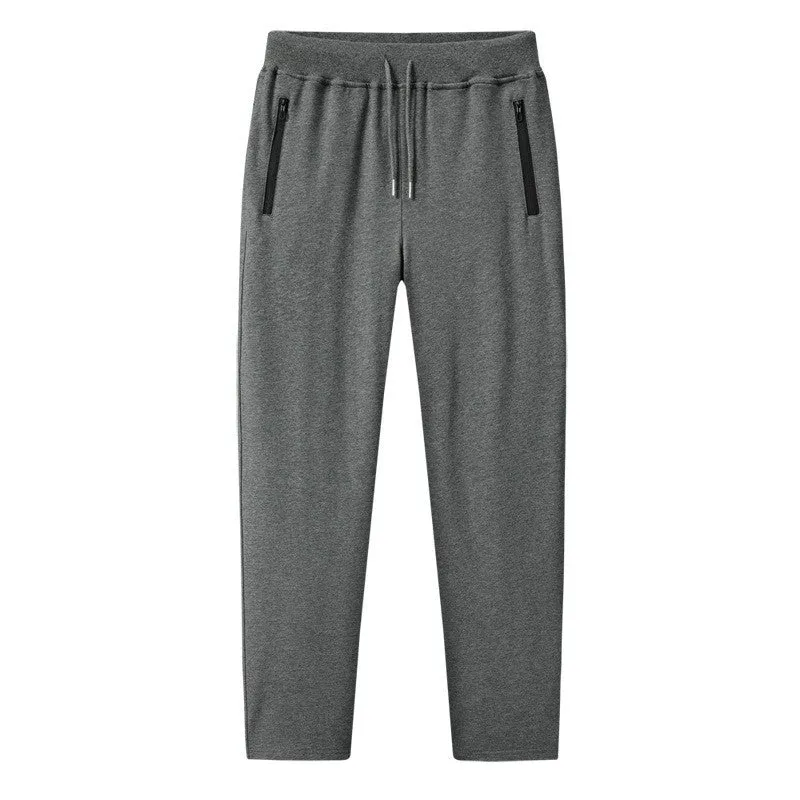 Men's thin leisure tapered knitted pants in black with ankle tie, standing on a neutral background