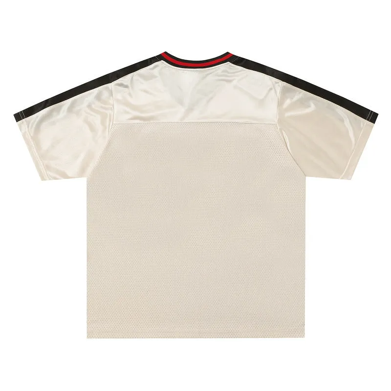 Apricot coloured loose sports top with V-neck design and drop-shoulder sleeves