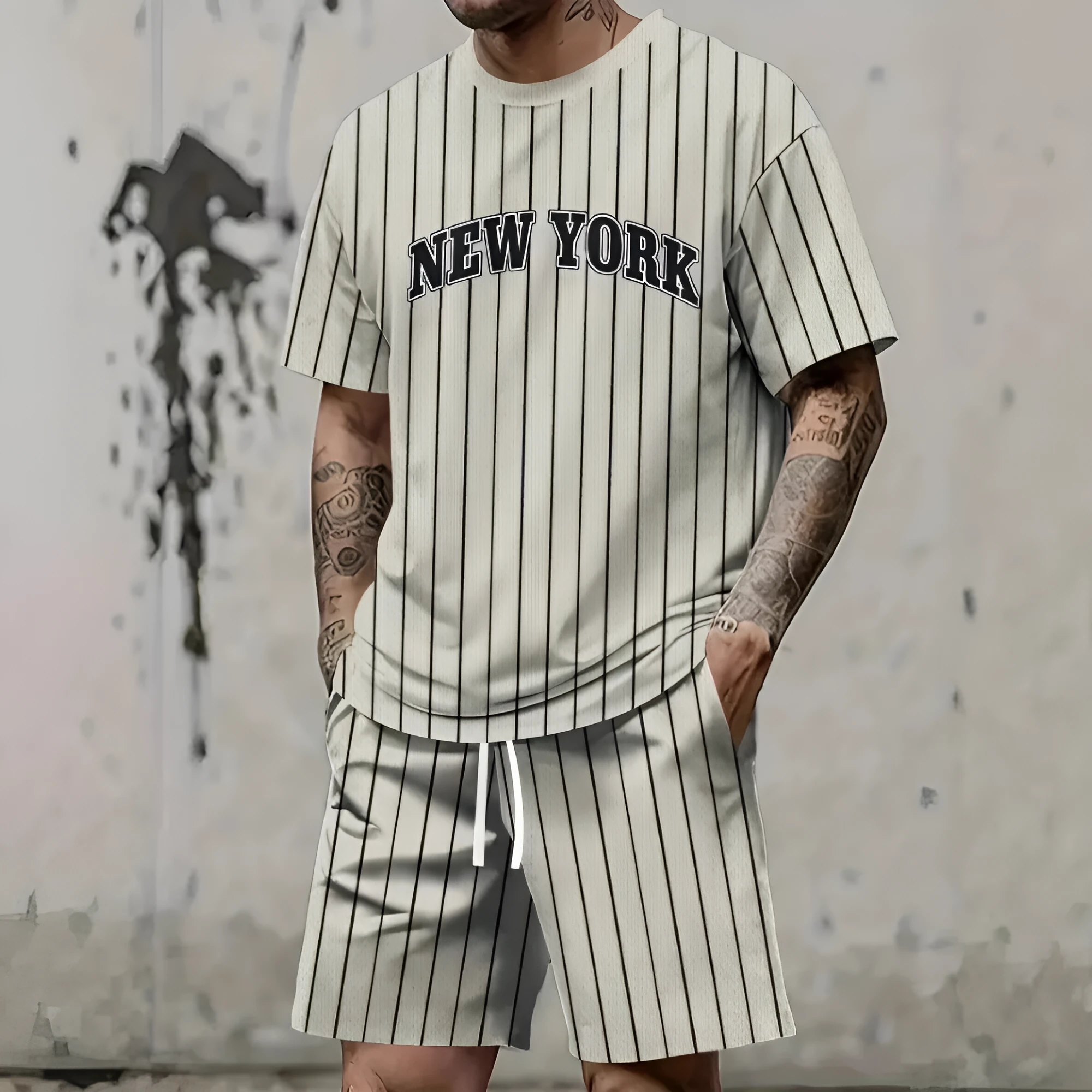 Men's grey 3D printed letter short sleeve top and matching shorts sportswear set laid flat.