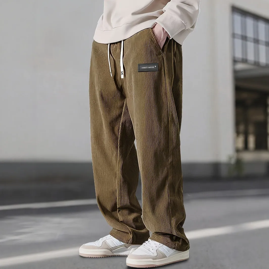 Men's corduroy straight-leg trousers in khaki with drawstring waist on a model, front view