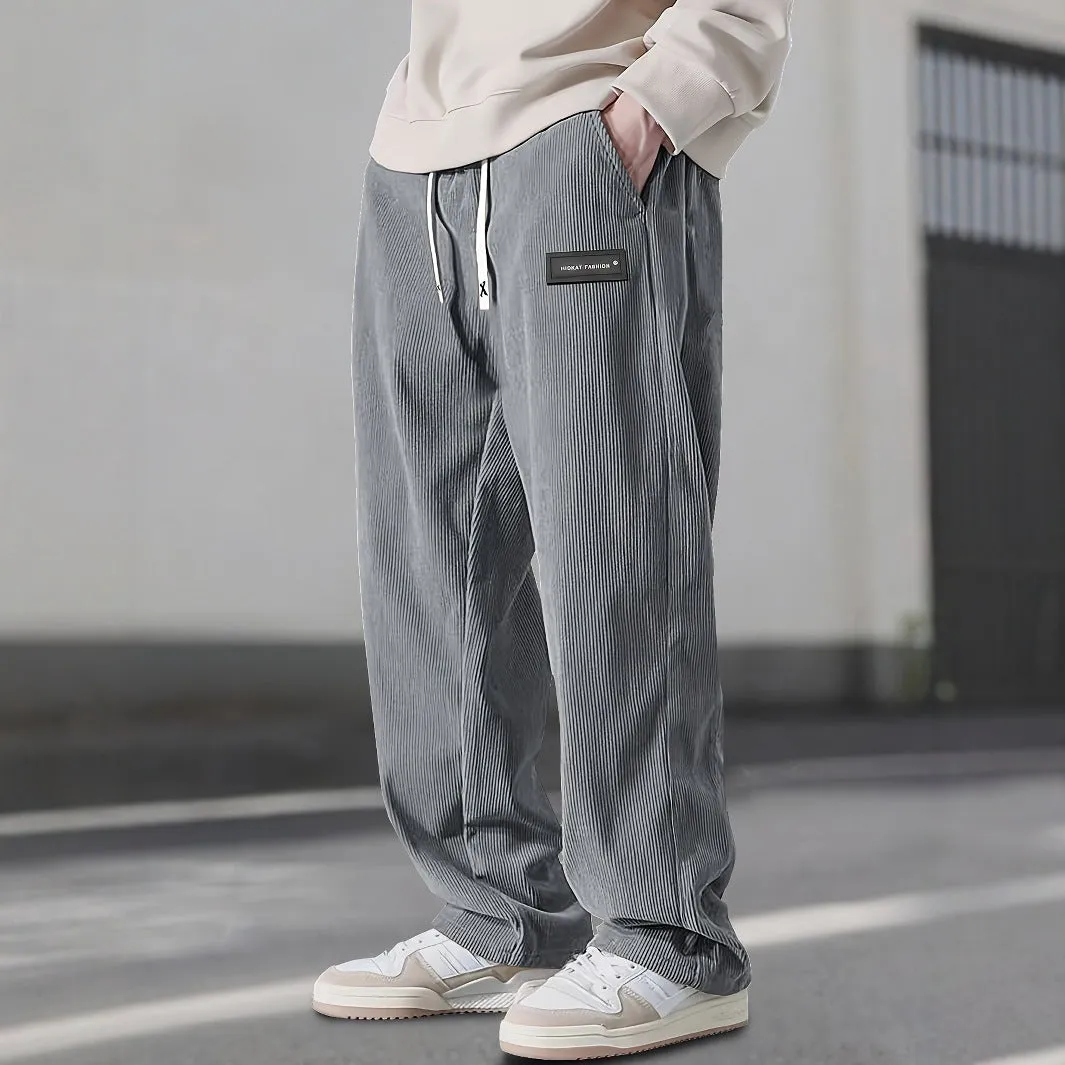 Men's corduroy straight-leg trousers in khaki with drawstring waist on a model, front view