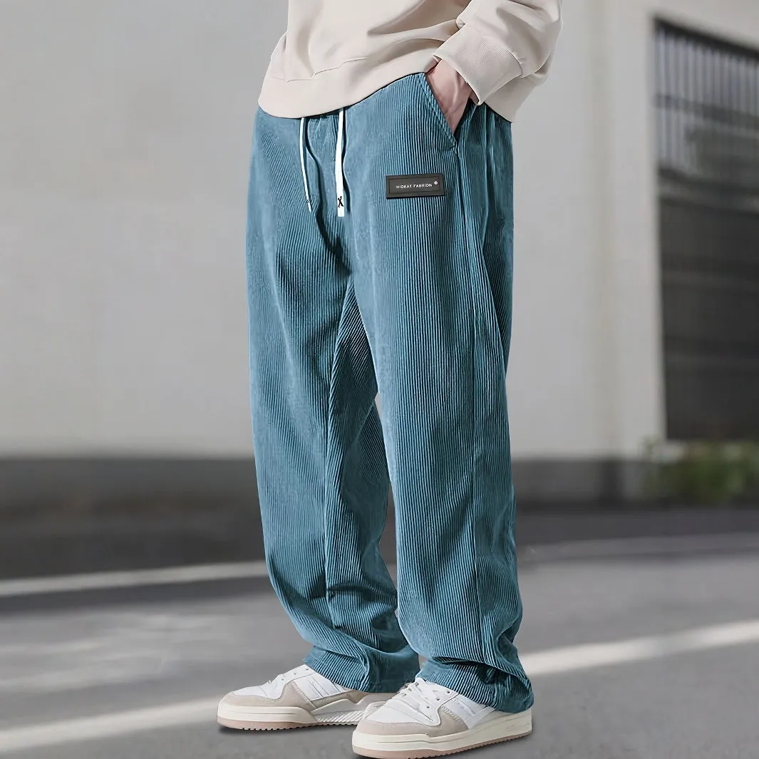 Men's corduroy straight-leg trousers in khaki with drawstring waist on a model, front view