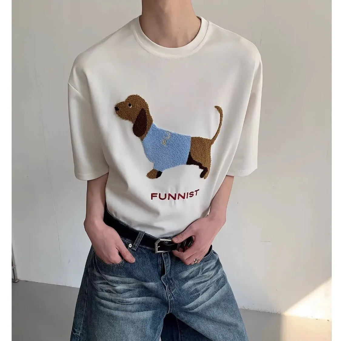Men's gray cotton t-shirt with an embroidered cartoon sausage dog holding a blue towel.