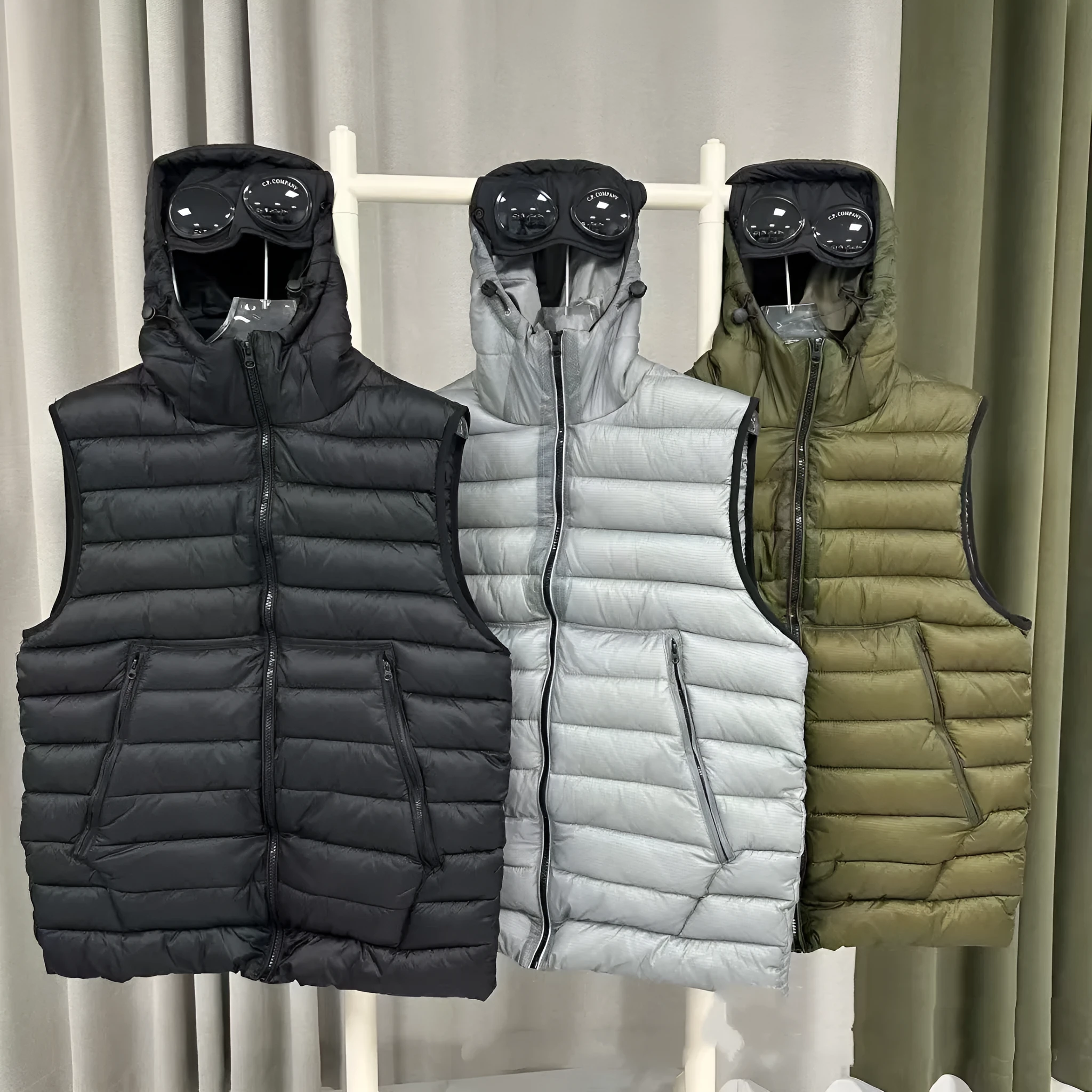 Men's loose hooded cotton vest jacket in black, side view, showing hood and zip closure