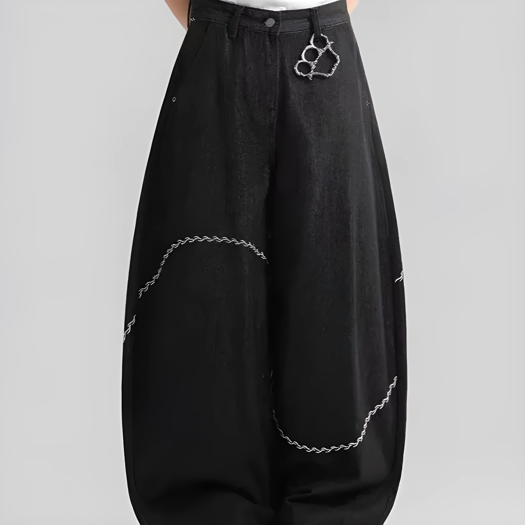 Black straight-leg denim trousers laid flat, showing zip fly and mid-waist design.