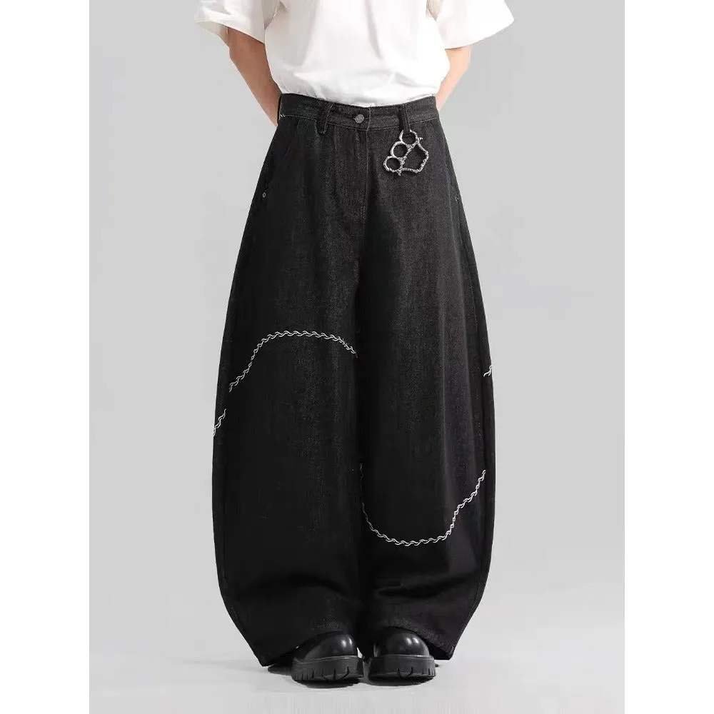 Black straight-leg denim trousers laid flat, showing zip fly and mid-waist design.