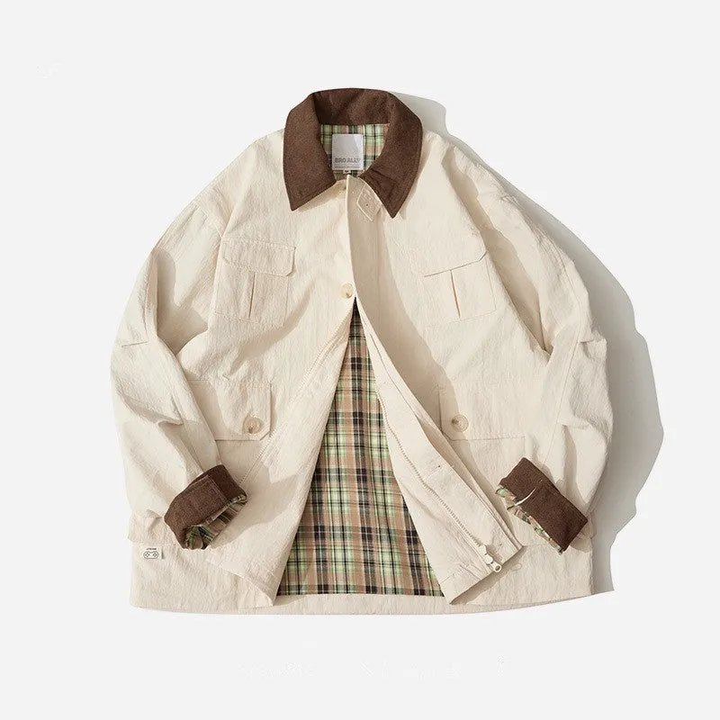 Green and apricot contrast colour casual jacket with side seam pockets on a hanger
