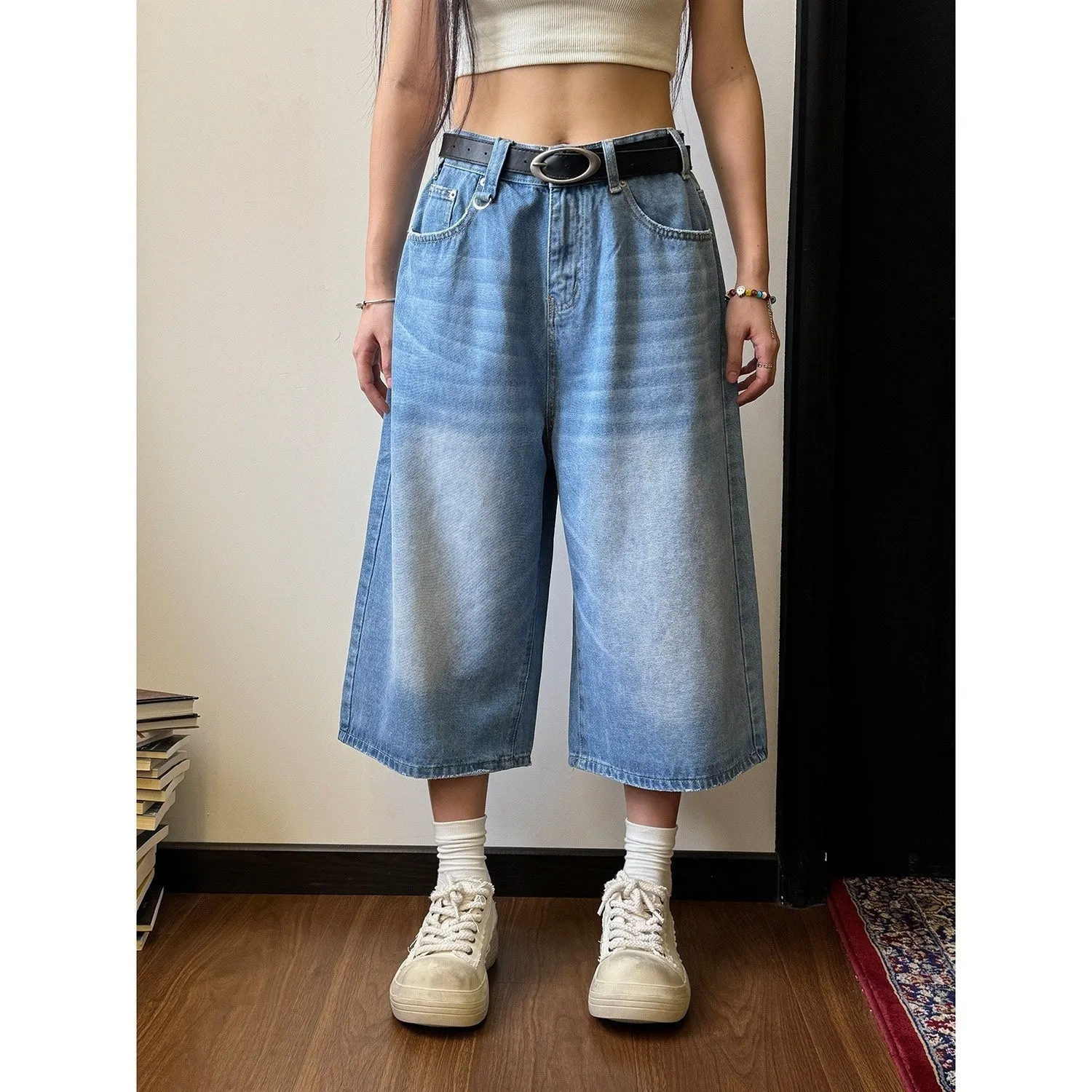 Men's loose fit straight leg denim shorts in blue, shown at a fifth pants length.