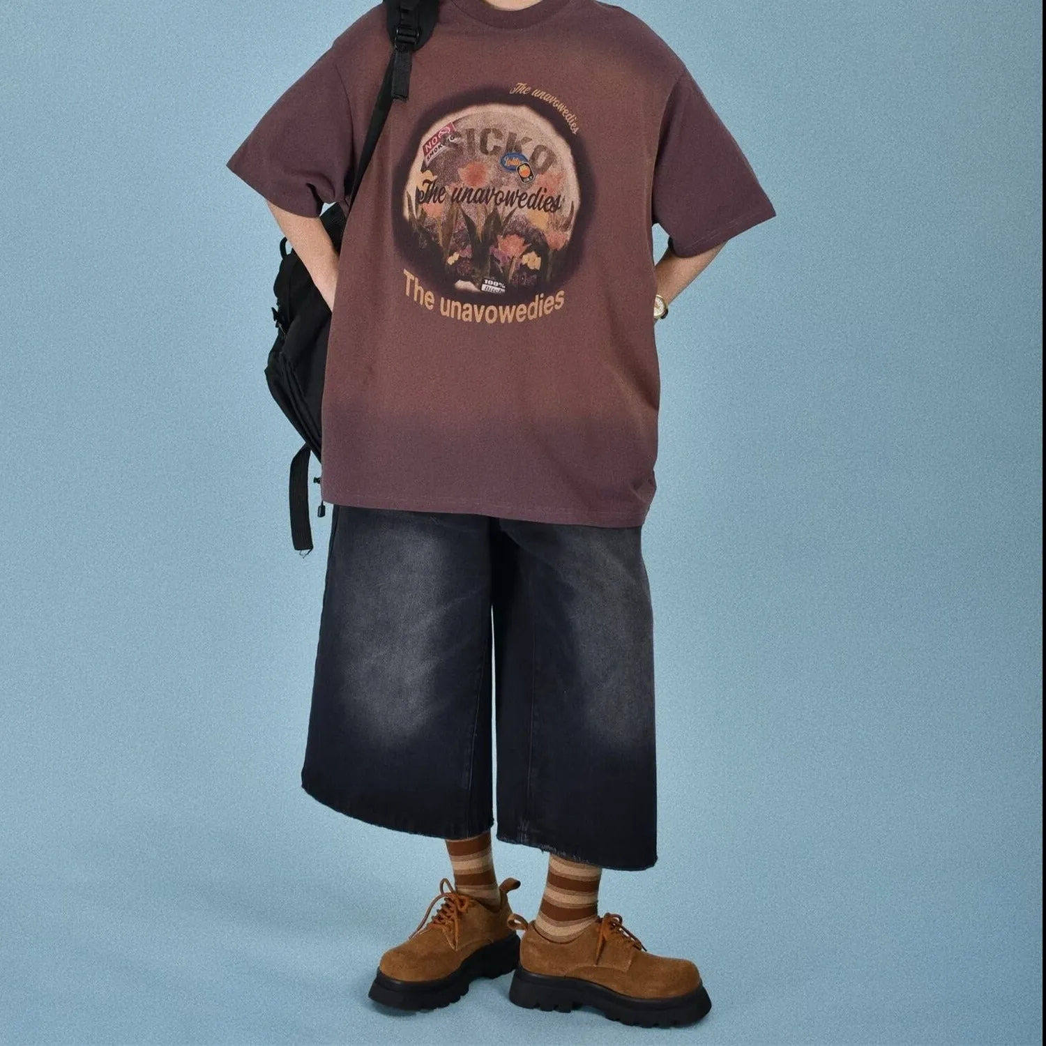 Men's loose fit straight leg denim shorts in blue, shown at a fifth pants length.
