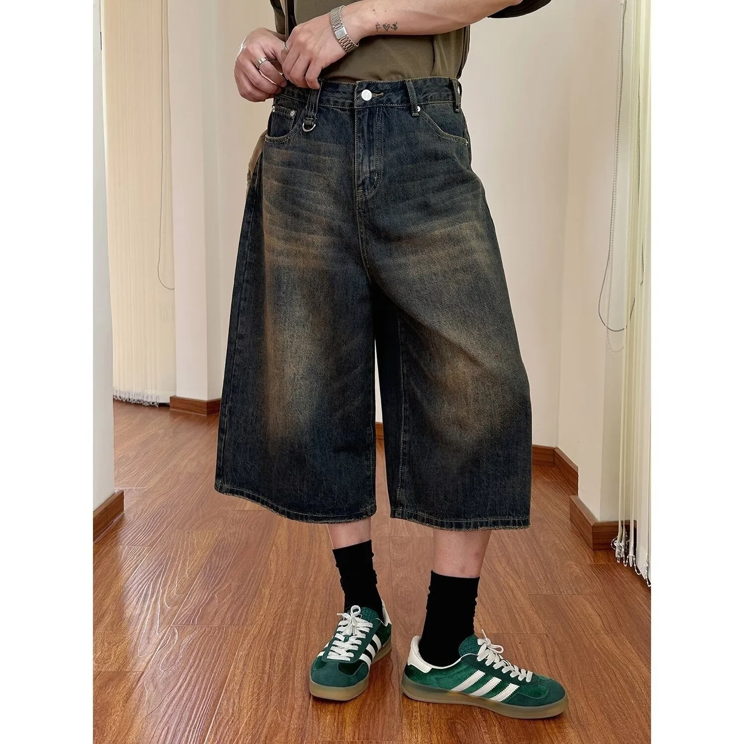 Men's loose fit straight leg denim shorts in blue, shown at a fifth pants length.