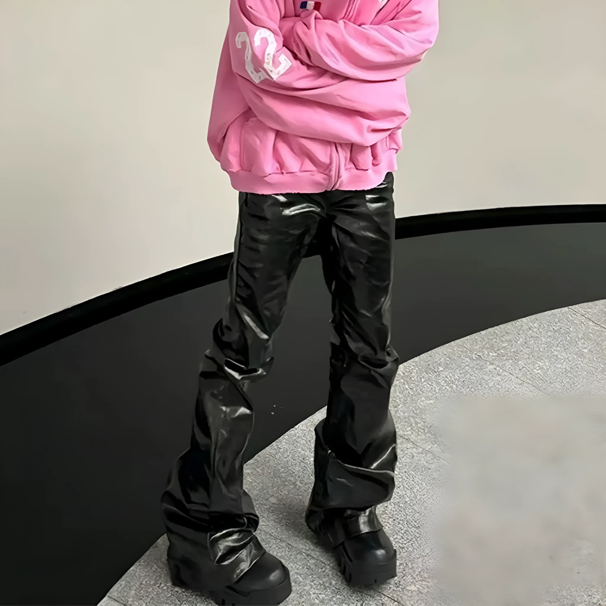 Black women's skinny jeans with a shiny patent leather coating on the denim fabric, shown in a straight-leg cut.