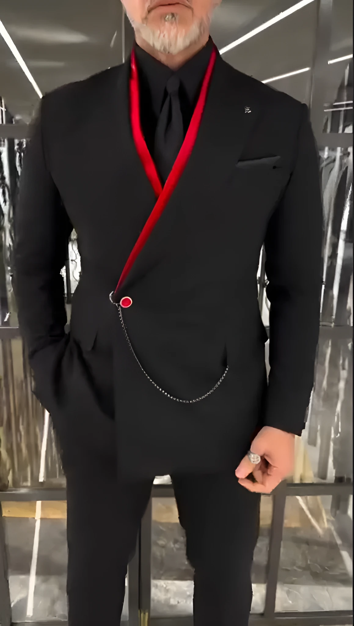 Fake double-layered black jacket with red inside and chain detail worn as streetwear