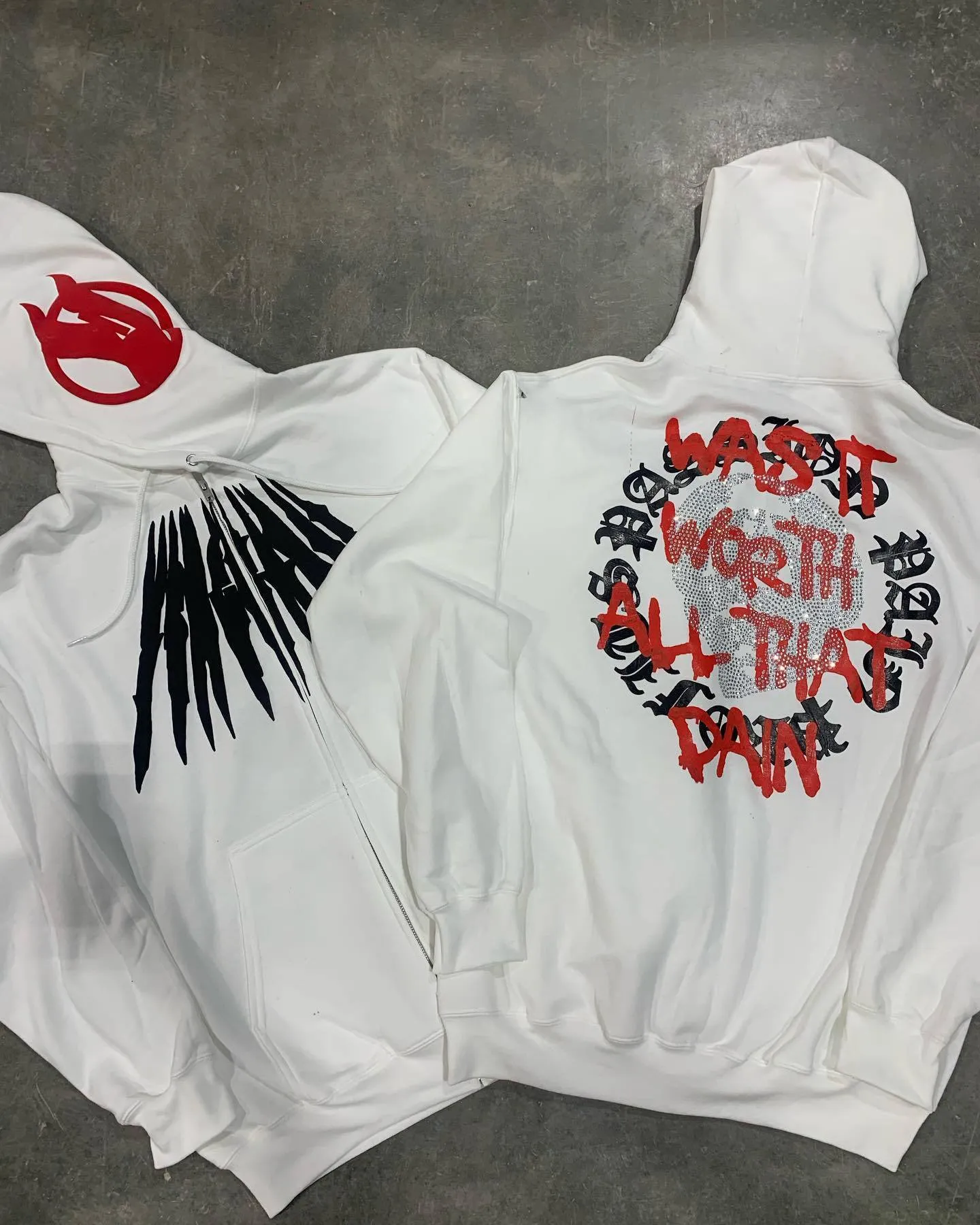 Black loose hooded sweatshirt with white skull and letter print, detailed with hot rhinestones.