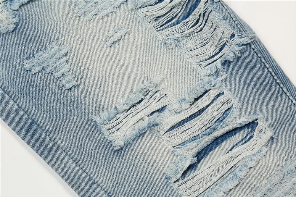 Men's light blue flared washed denim jeans with zipper fly on a model