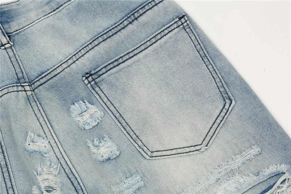 Men's light blue flared washed denim jeans with zipper fly on a model