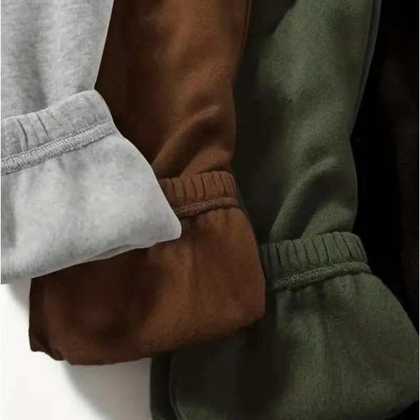 Four women's polyester sweatpants in black, green, brown, gray, stacked together