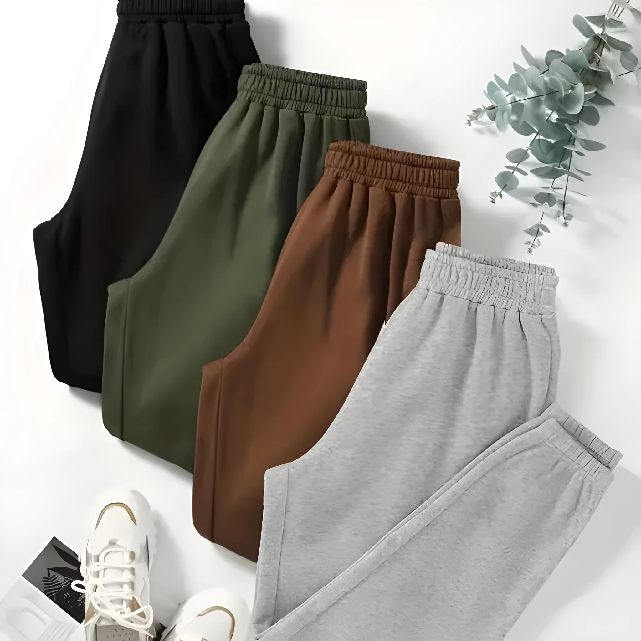 Four women's polyester sweatpants in black, green, brown, gray, stacked together
