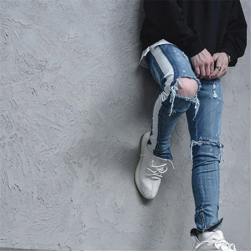 Men's cotton ripped jeans in black showing distressed knee details, front view