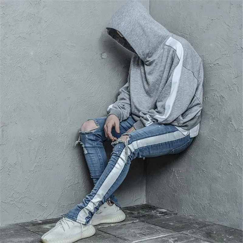 Men's cotton ripped jeans in black showing distressed knee details, front view