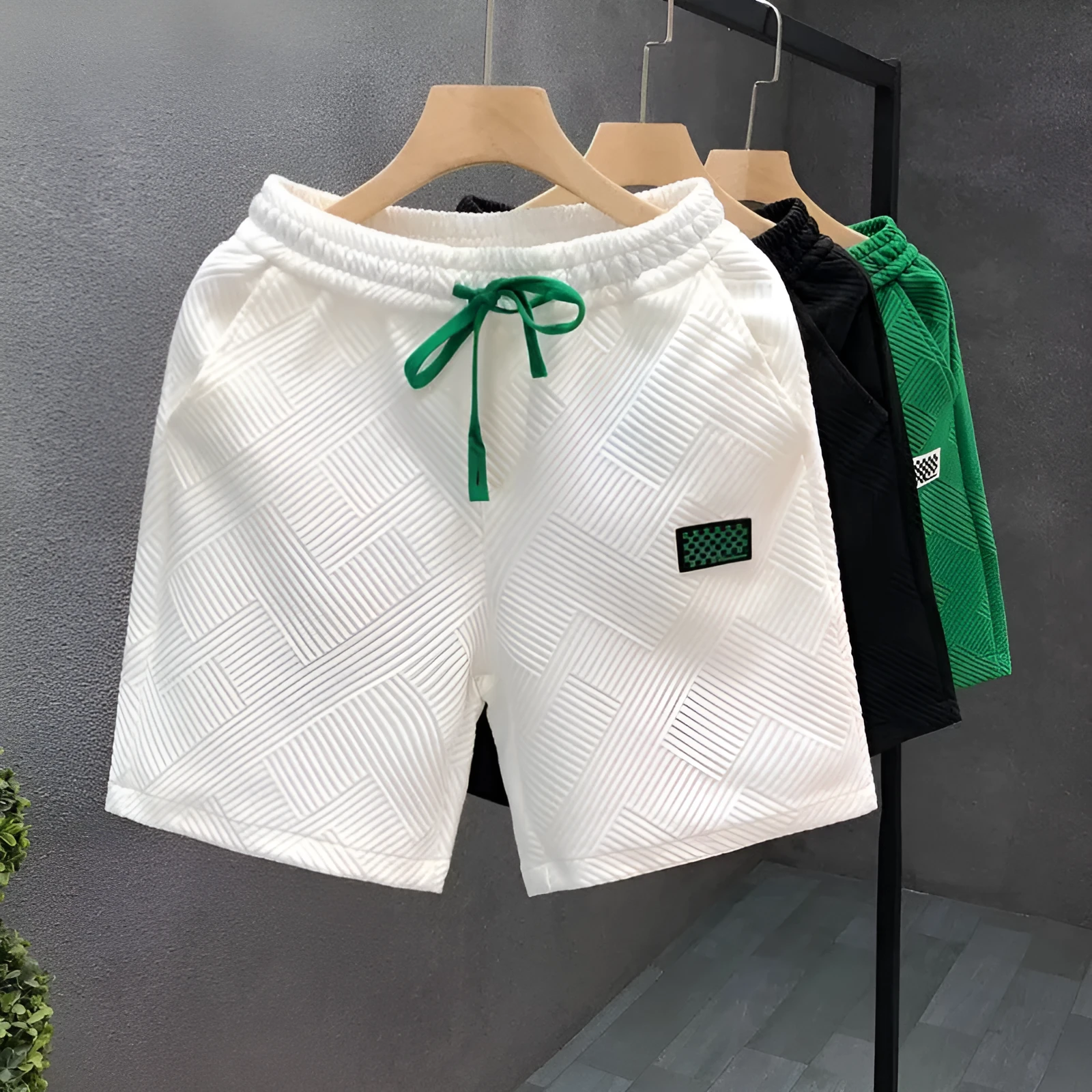 Men's solid colour casual sports shorts with micro elasticity in white, black, or green options