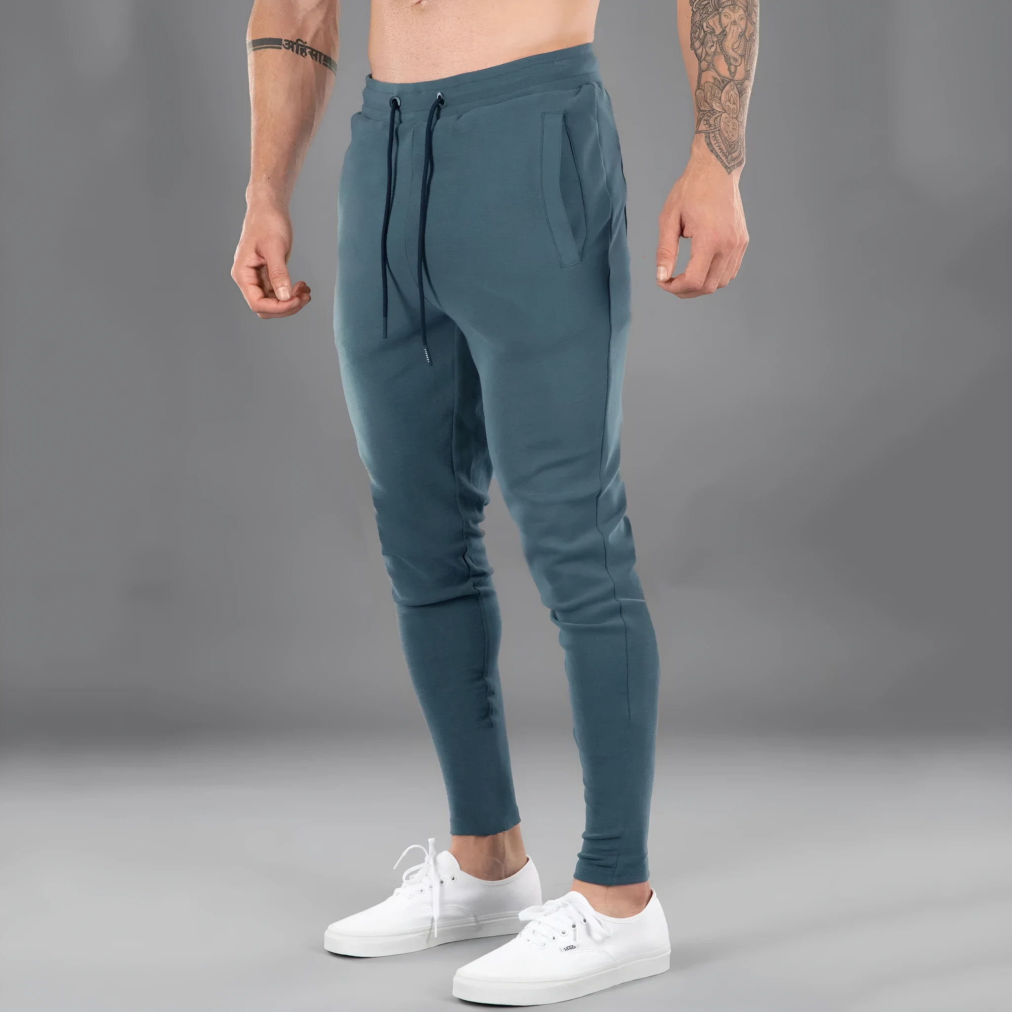 Men's cotton skinny stretch sports pants in black with moisture wicking fabric, middle waist design