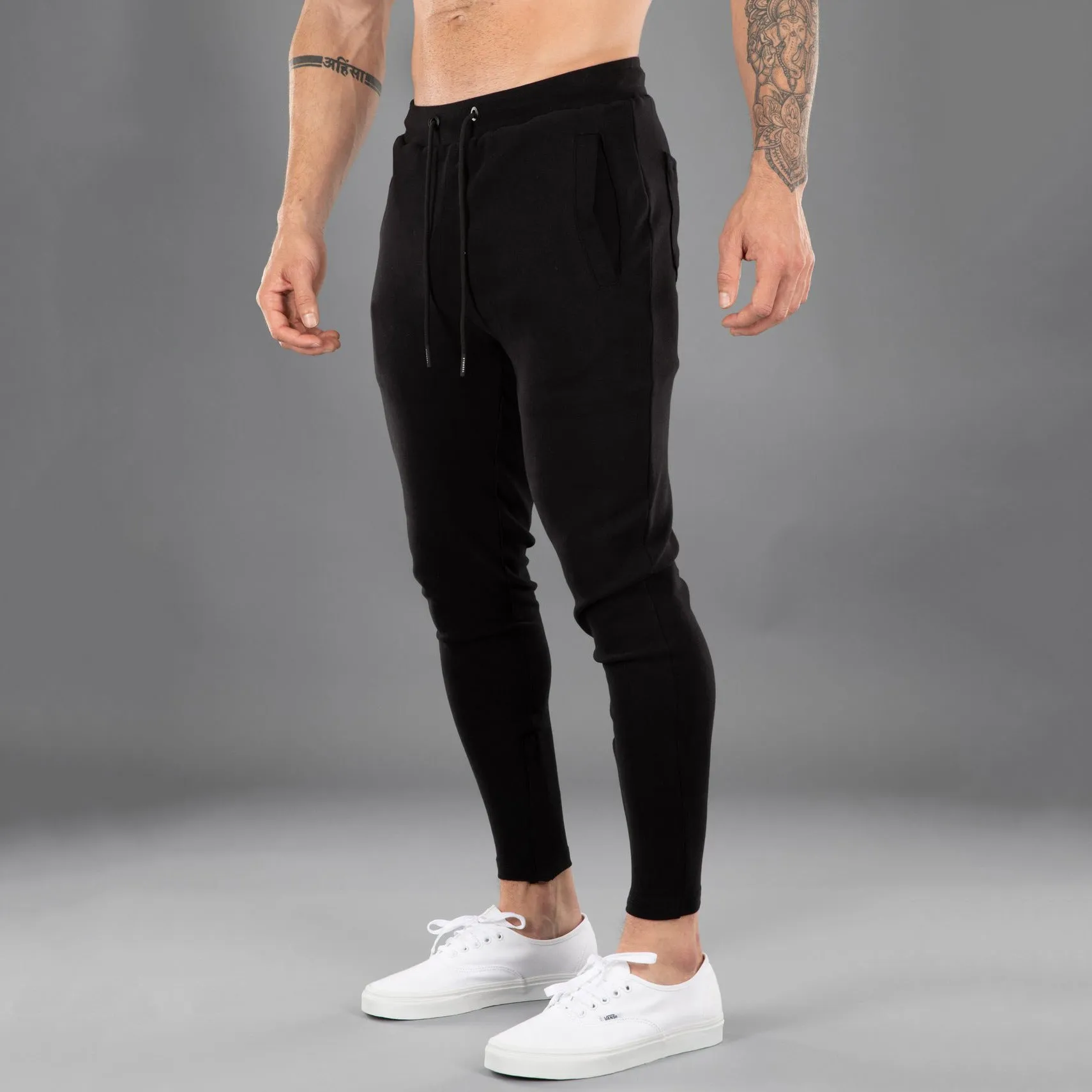 Men's cotton skinny stretch sports pants in black with moisture wicking fabric, middle waist design