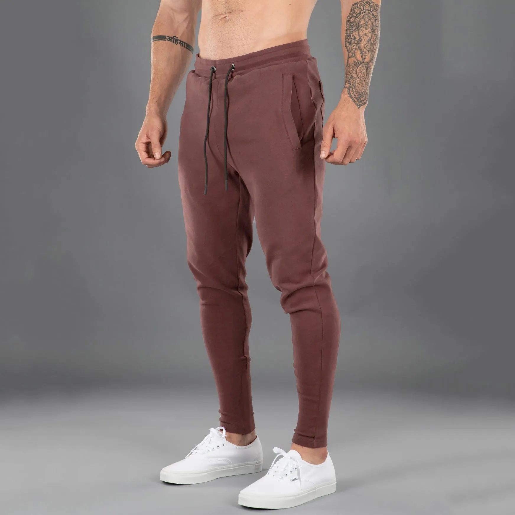 Men's cotton skinny stretch sports pants in black with moisture wicking fabric, middle waist design