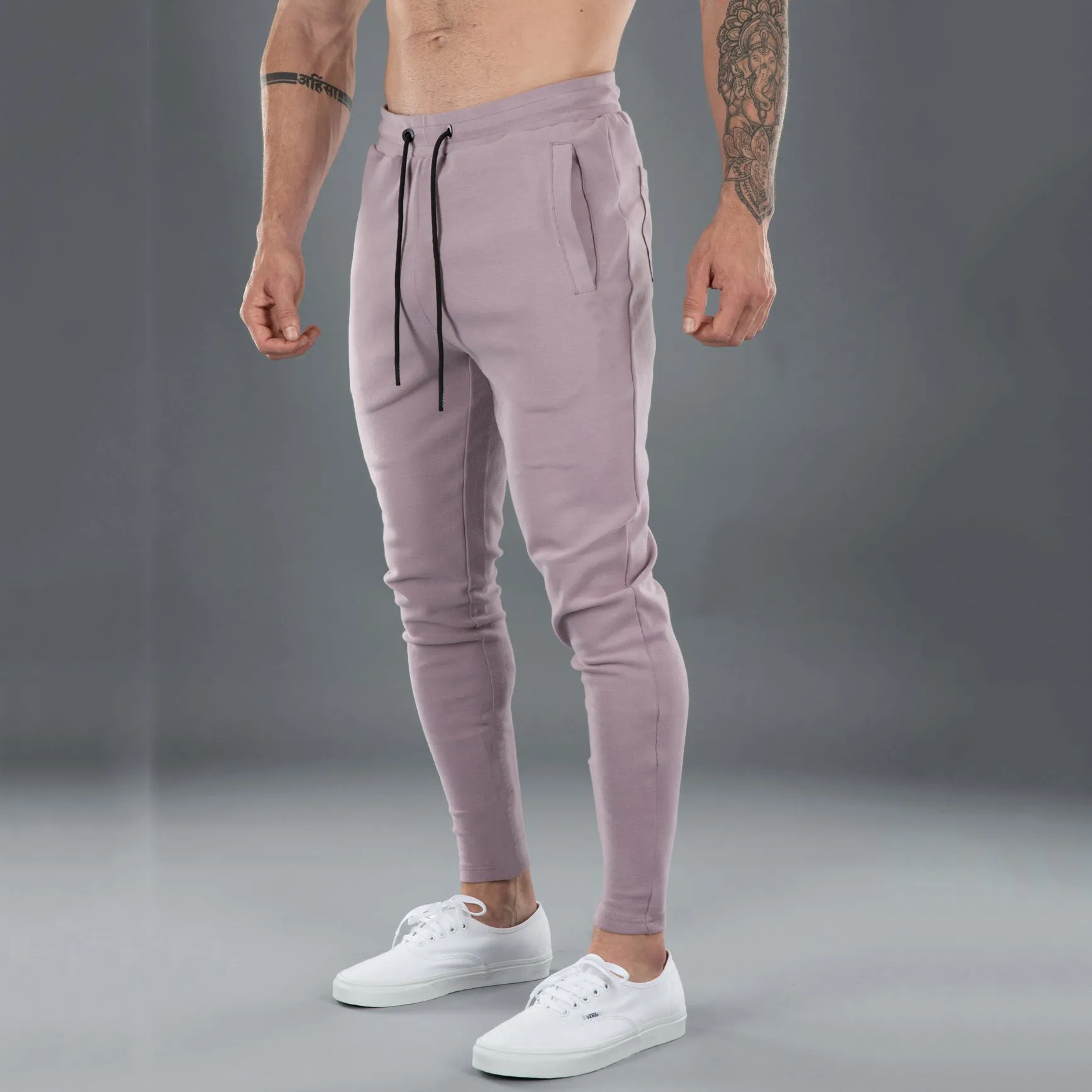 Men's cotton skinny stretch sports pants in black with moisture wicking fabric, middle waist design