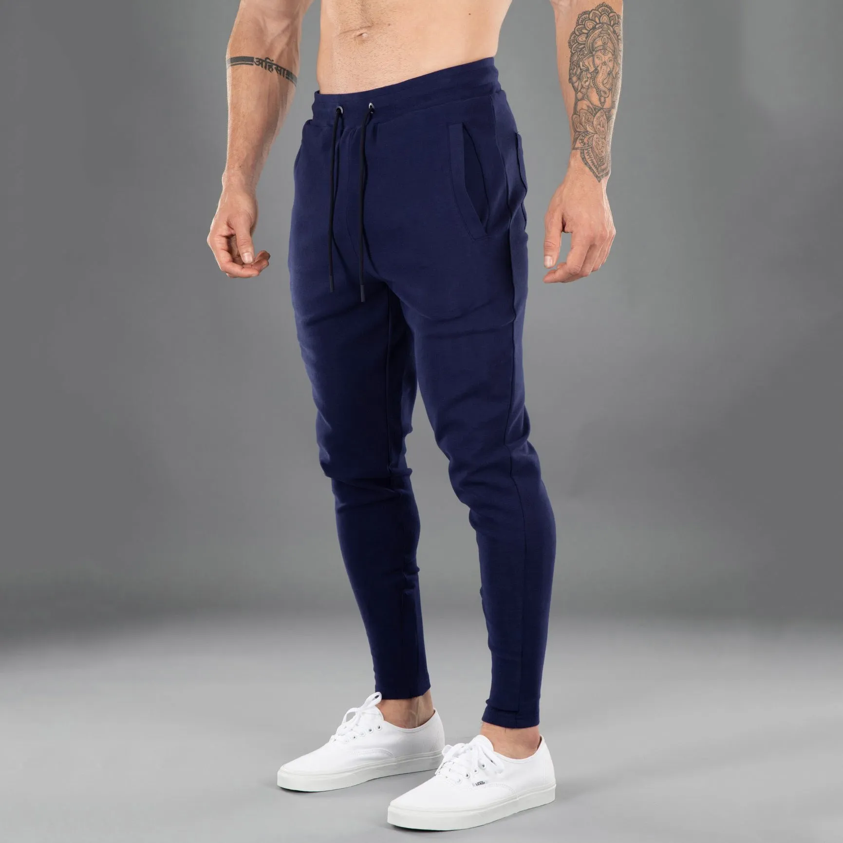 Men's cotton skinny stretch sports pants in black with moisture wicking fabric, middle waist design