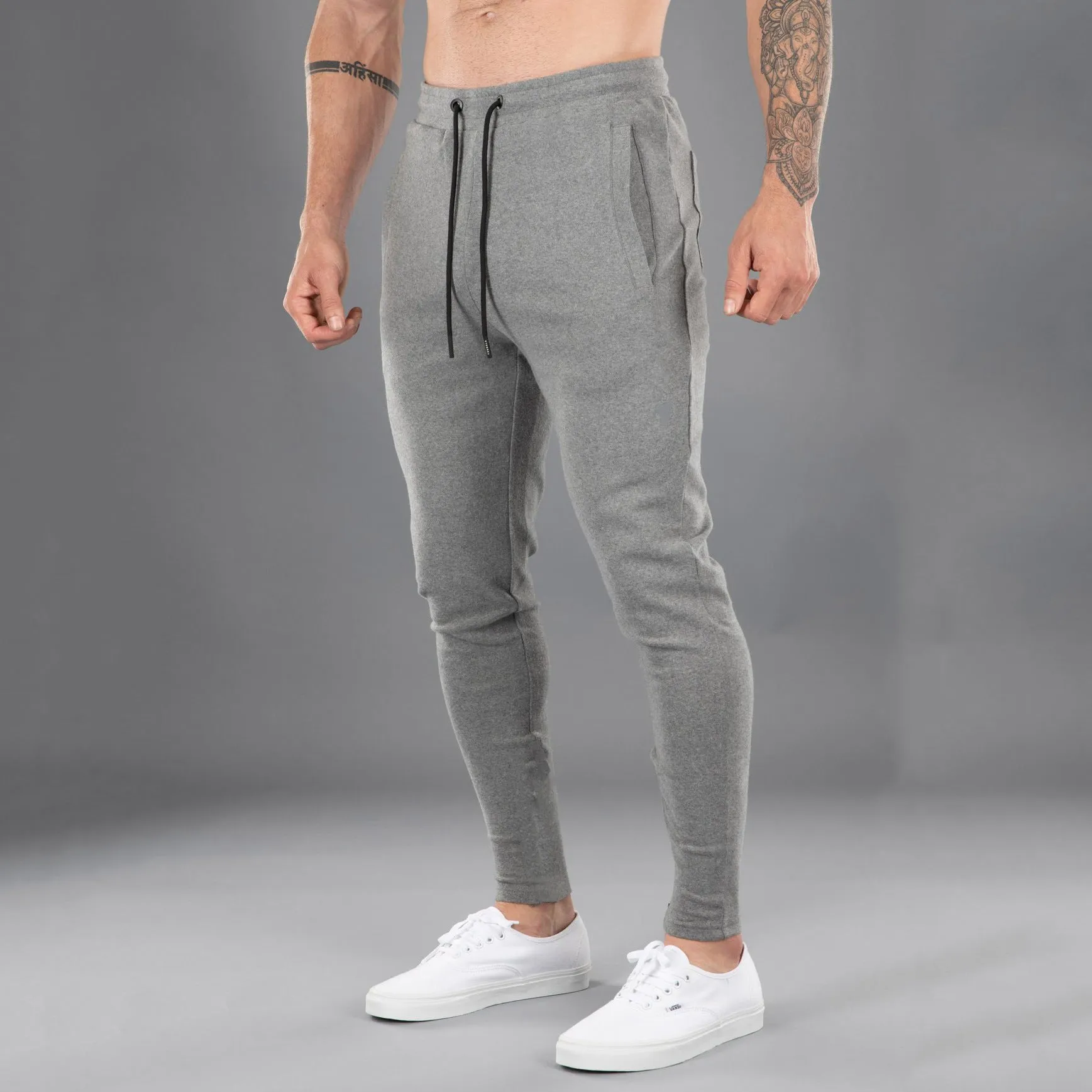 Men's cotton skinny stretch sports pants in black with moisture wicking fabric, middle waist design
