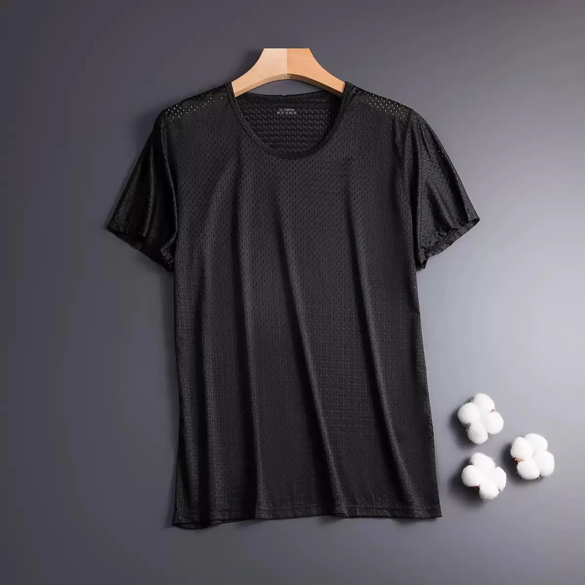 Man wearing a grey ice silk short sleeve crew neck t-shirt showing mesh fabric texture.