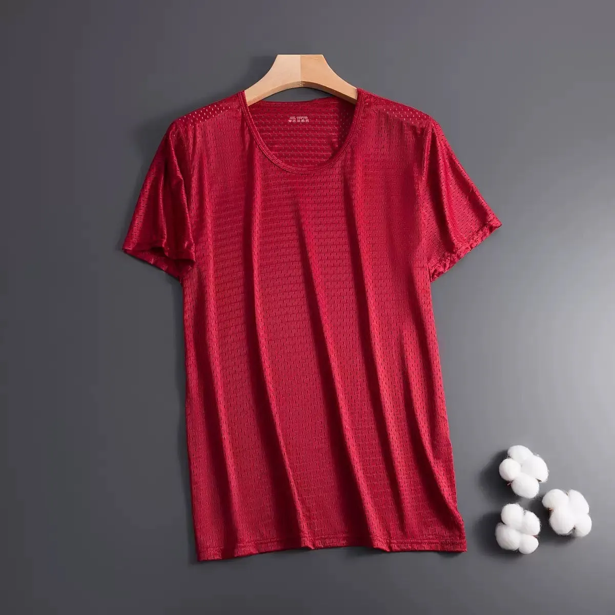 Man wearing a grey ice silk short sleeve crew neck t-shirt showing mesh fabric texture.