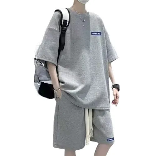 A waffle-textured leisure sports suit consisting of a short-sleeve top and shorts in a neutral colour.