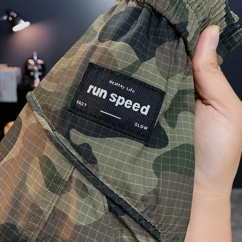 Man wearing loose-fit camouflage cargo shorts with cargo pockets and an elasticated waistband.
