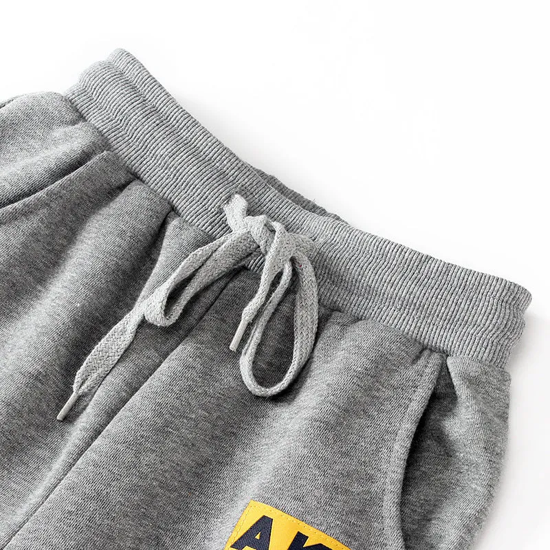 Boys' cotton track pants in black size 120cm on a child model