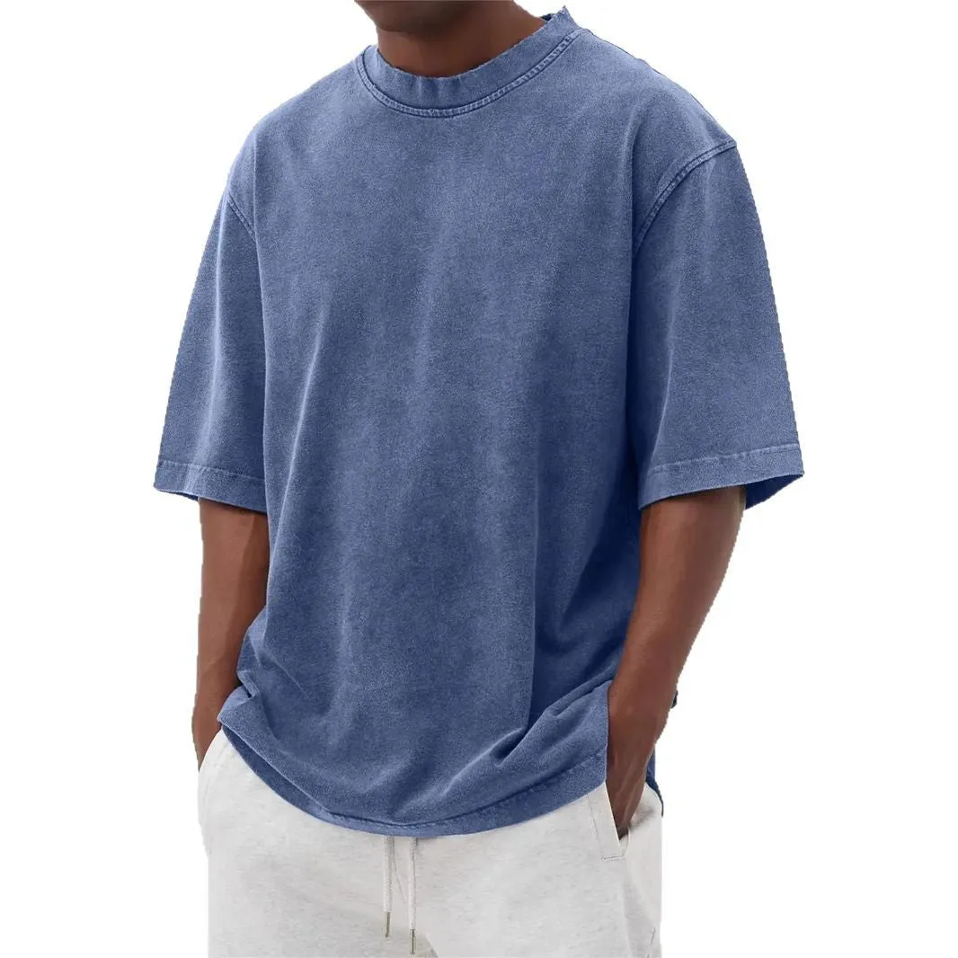 Man wearing a loose-fit, distressed army green pullover T-shirt with half sleeves.