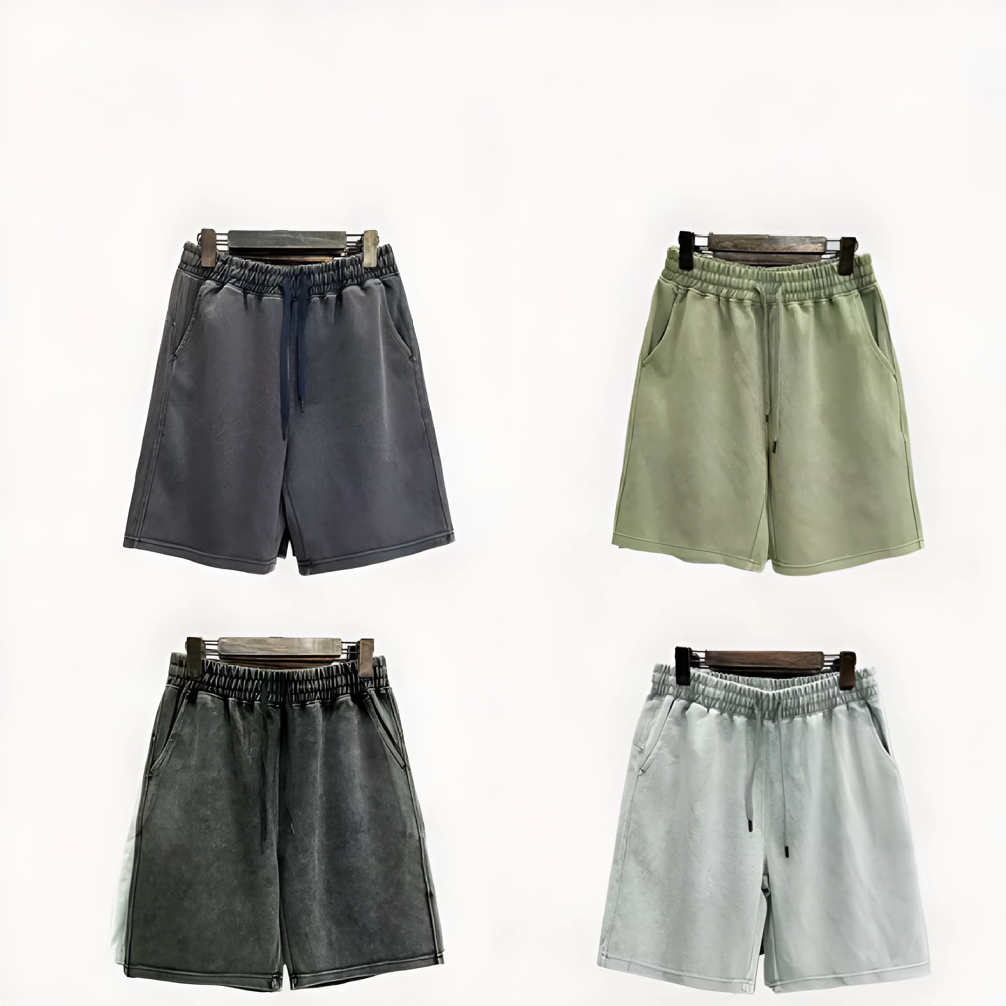 Man wearing solid colour distressed cotton shorts with a loose casual straight-leg fit