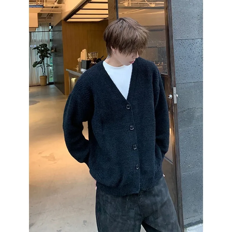 Men's solid colour V-neck knitted cardigan sweater in a loose fit on a hanger.