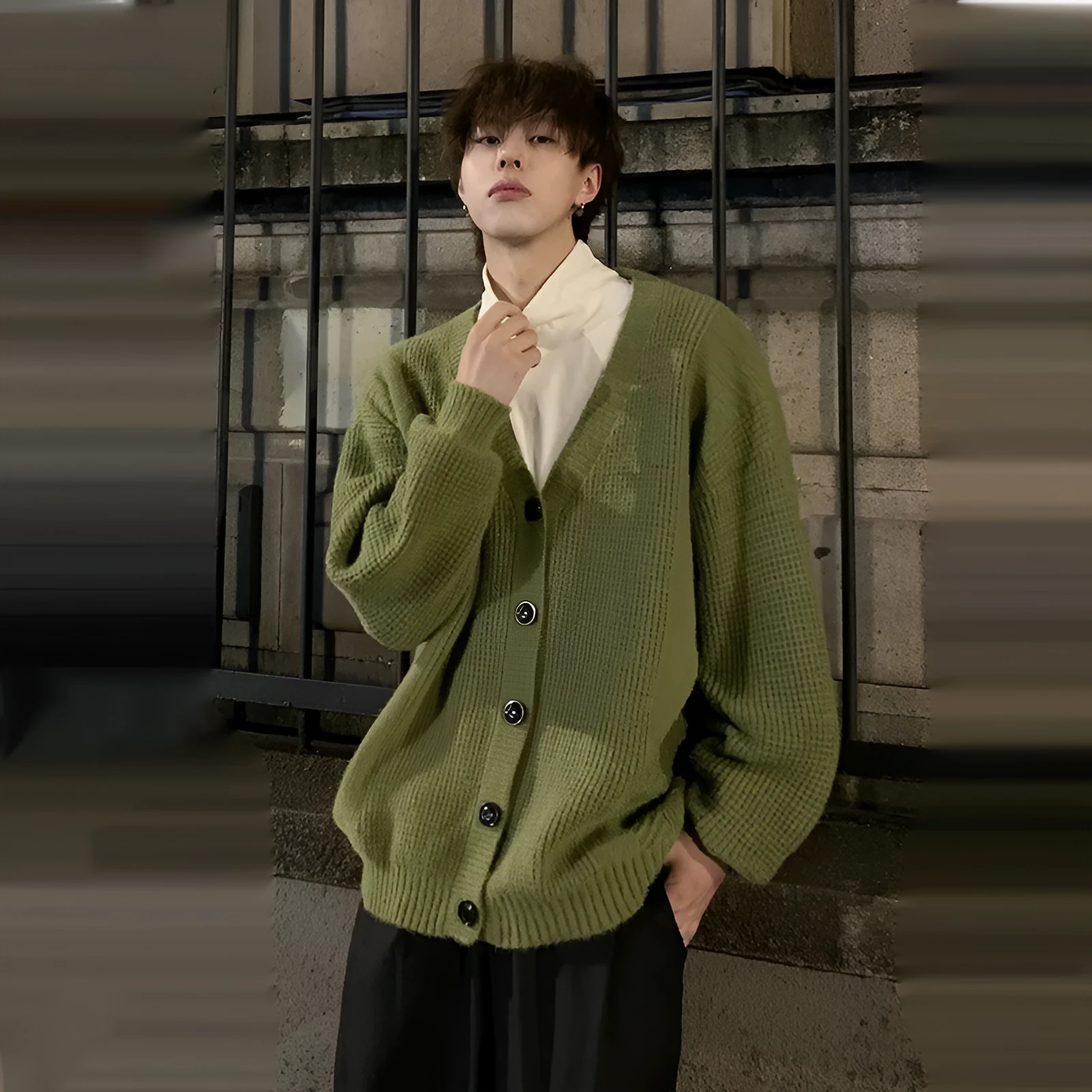 Men's solid colour V-neck knitted cardigan sweater in a loose fit on a hanger.
