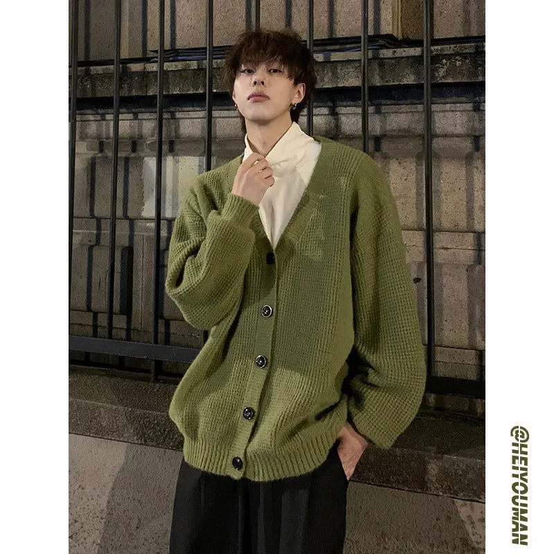 Men's solid colour V-neck knitted cardigan sweater in a loose fit on a hanger.
