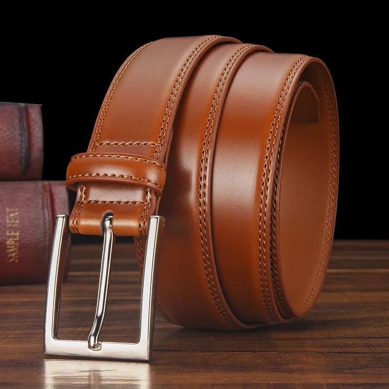 Men's black genuine leather belt with silver alloy pin buckle on a flat surface