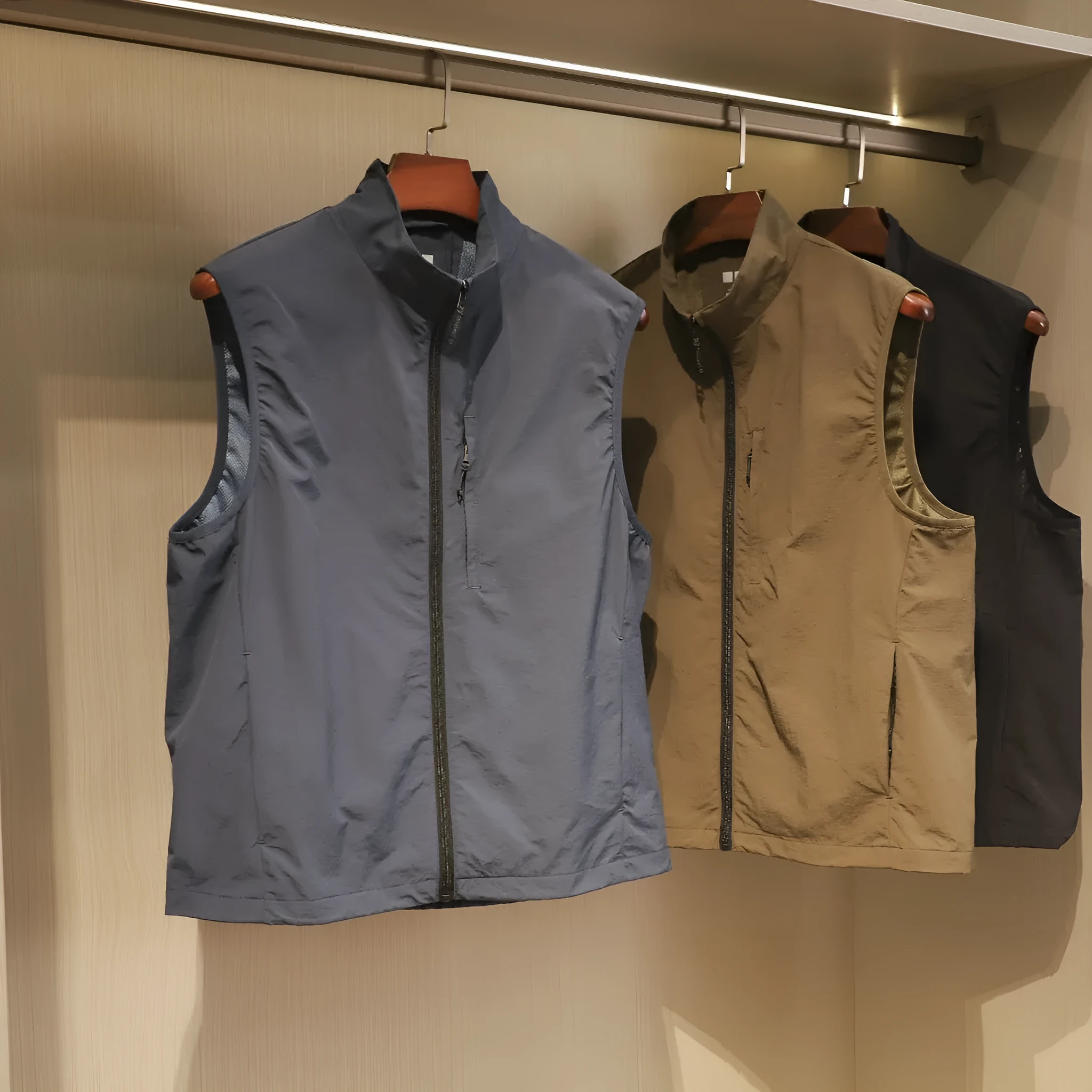 Men's thin nylon bandage-style vest in army green with side seam pockets on a hanger.