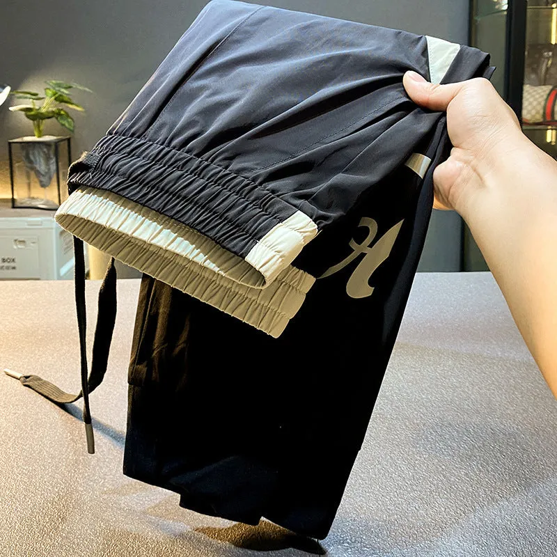 Man wearing black ultra-thin ice silk cropped trousers with a banded ankle cuff.