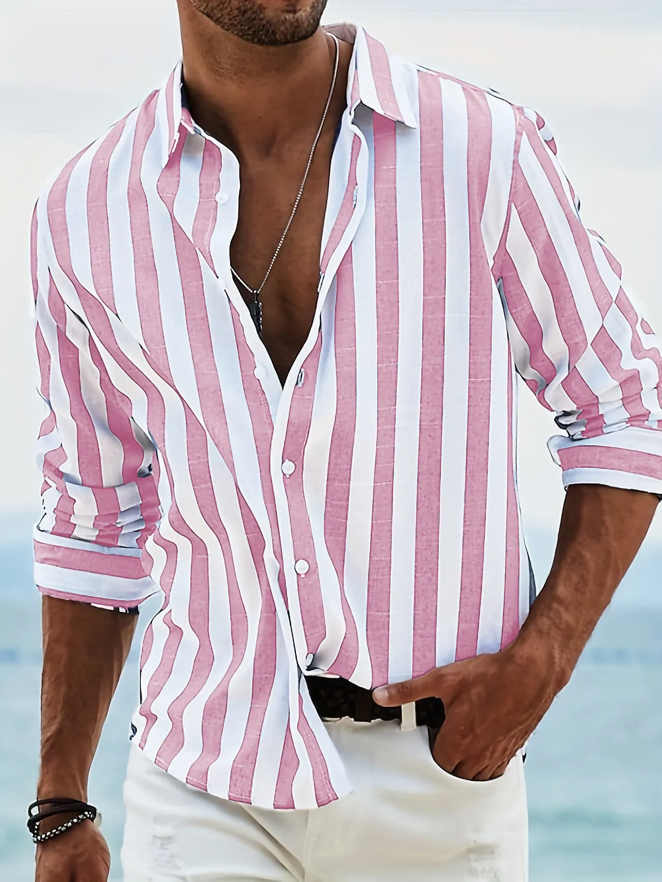 Man wearing a loose grey striped casual long-sleeved shirt with a cardigan style.