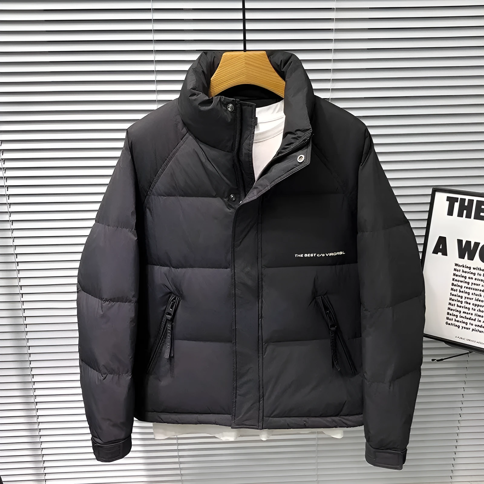 Men's stand collar thick down jacket in solid black colour on a plain background