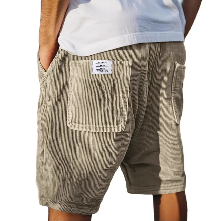 Men's straight cut multi-pocket corduroy shorts in grey shown on a hanger.