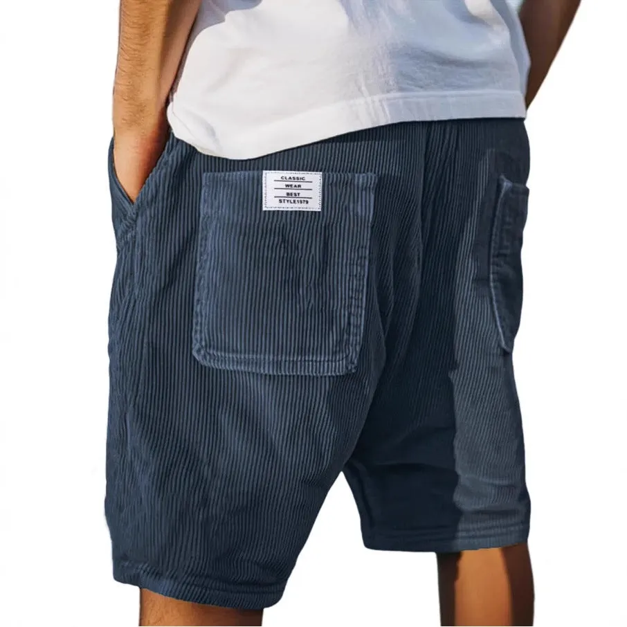 Men's straight cut multi-pocket corduroy shorts in grey shown on a hanger.