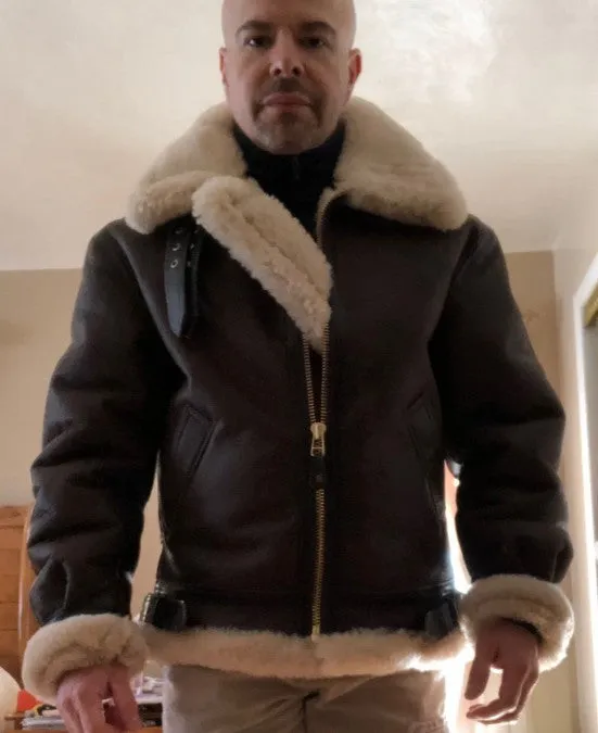 Men's black winter faux leather jacket with fur lining, front zipper, and straight hem, shown from front