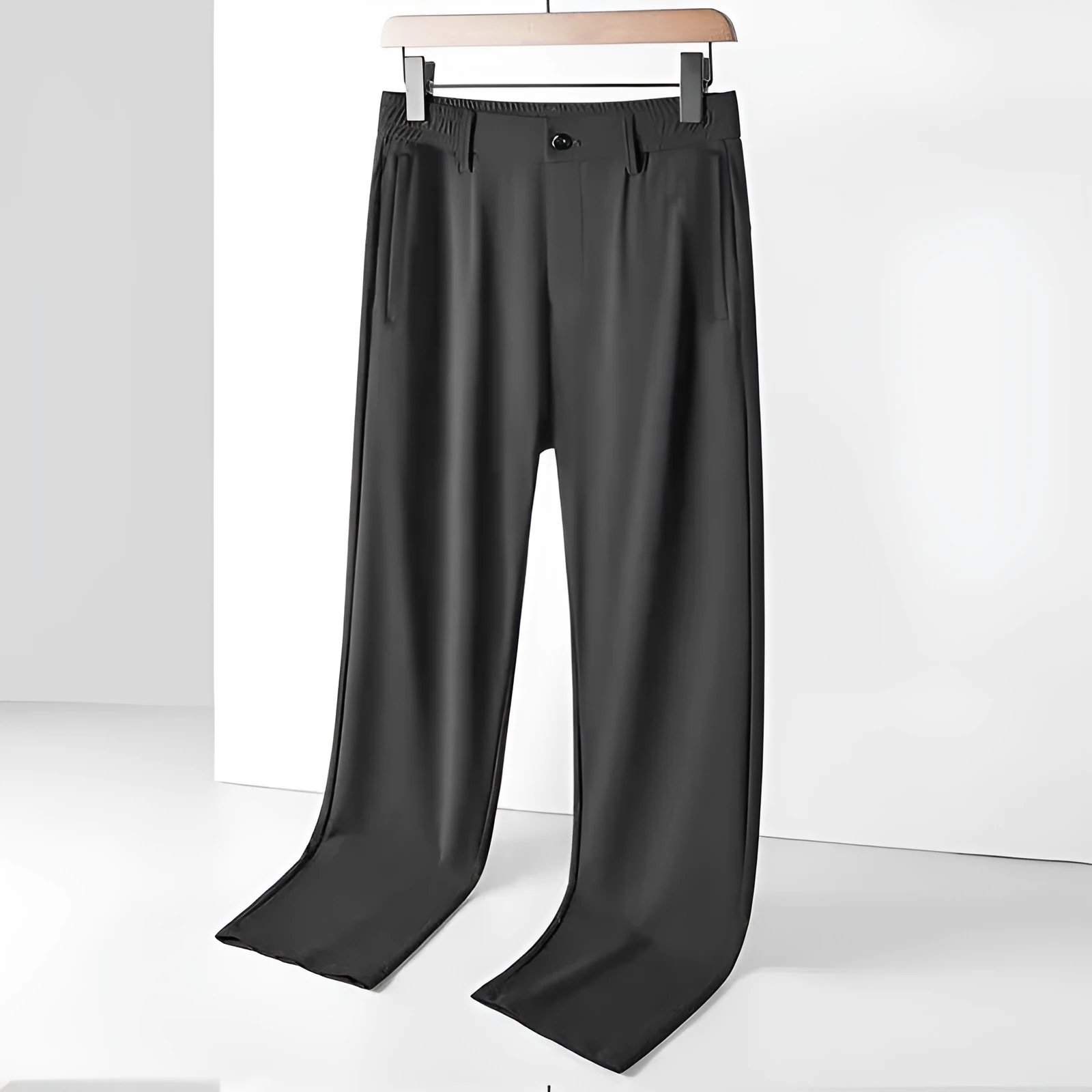 Man wearing black ice silk straight-leg loose casual trousers with an elastic waist.