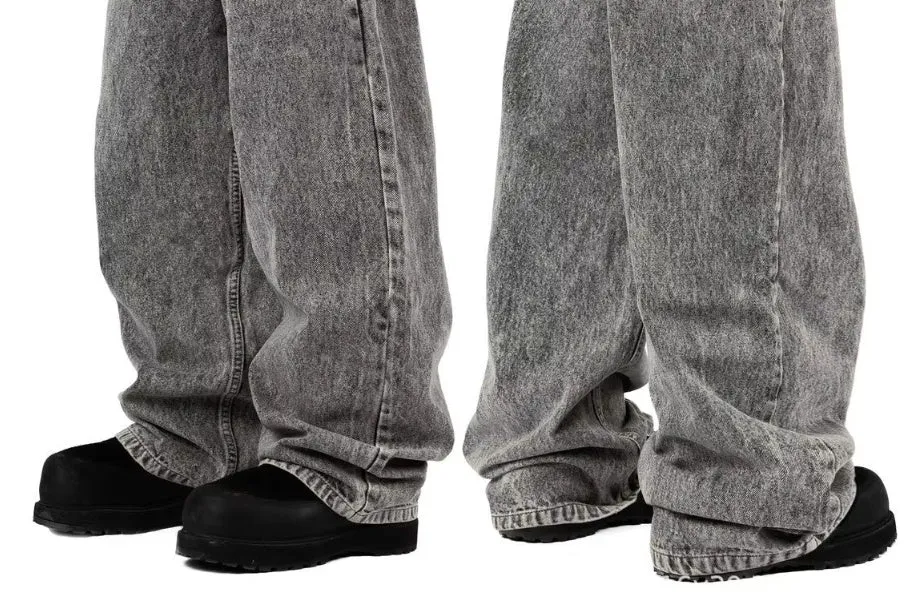 Grey loose straight-leg denim trousers for men and women laid flat, showing mid waist and classic cut.